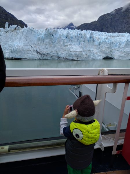 Tommy takes a picture of the glacier. Camera and wardrobe supplied by Mom.