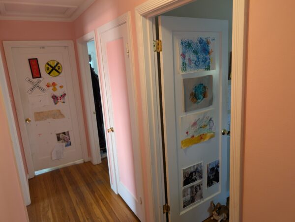 A view of the hallway, pretty in freshly painted pink.