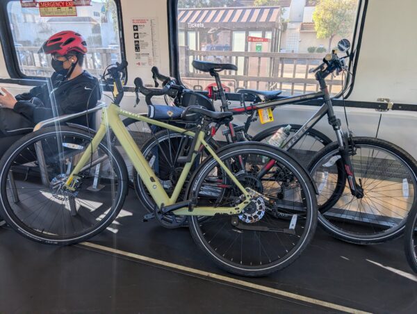 three bikes stacked on Caltrain, in a sloppy fashion