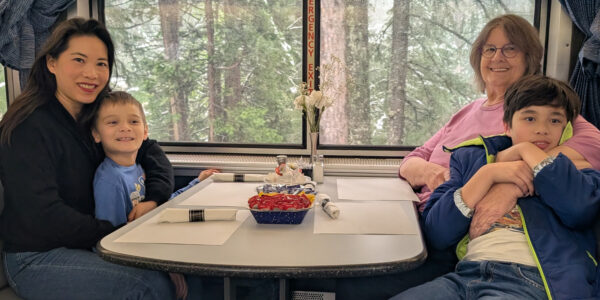 Mom holds Younger Son. Grandma holds Older Son. Dad took the picture.