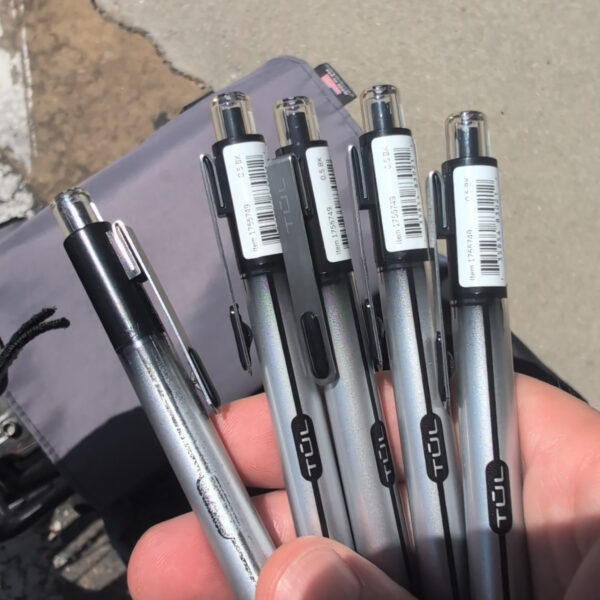 Danny holds in his hand one well-worn pen, and four new ones.